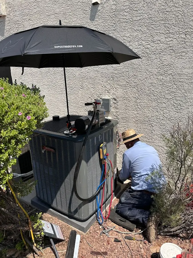 HVAC technician performing outdoor AC maintenance in Wildwood